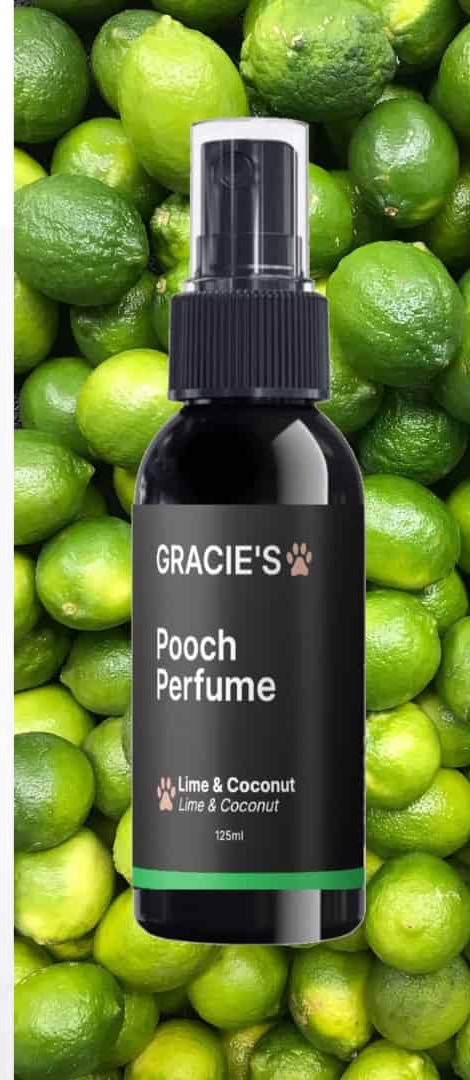 Gracie's Pooch Perfume Lime & Coconut bottle on a bed of limes